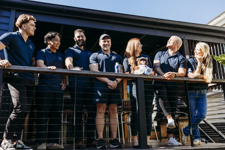 A group of Brothers laughing together on a deck
